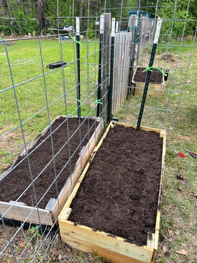 The garden gate flower beds built, set and filled with soil. Complete with Archway. 